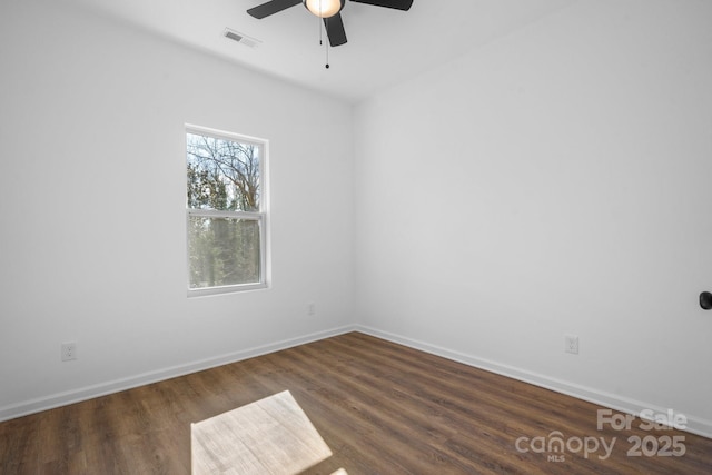 spare room with dark hardwood / wood-style floors and ceiling fan