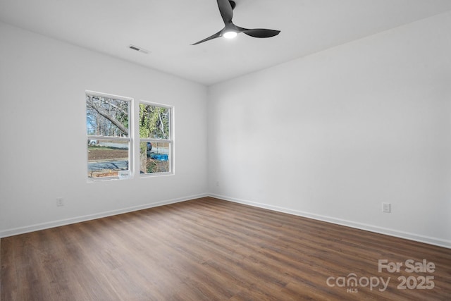 empty room with dark wood-type flooring and ceiling fan