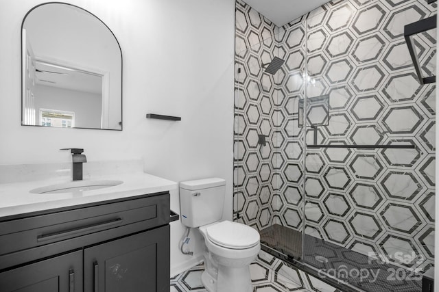 bathroom featuring walk in shower, vanity, and toilet