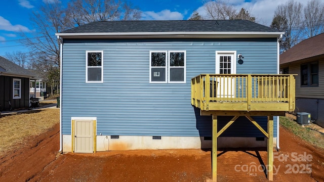 rear view of house with a wooden deck and cooling unit