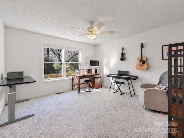 office with carpet floors, a textured ceiling, and ceiling fan