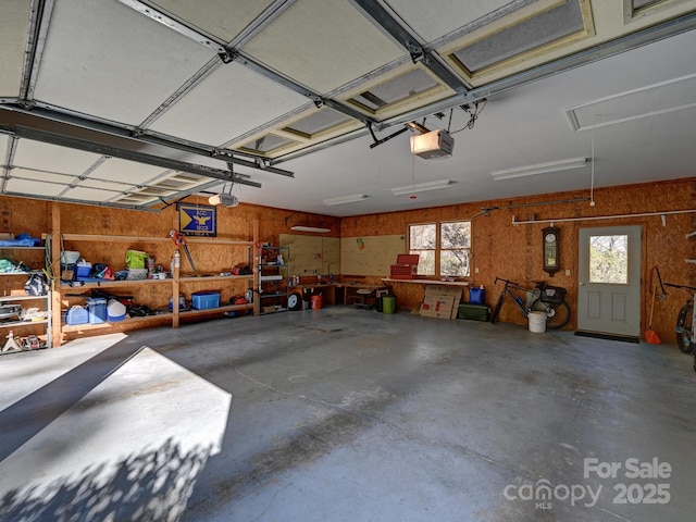 garage featuring a garage door opener and a workshop area