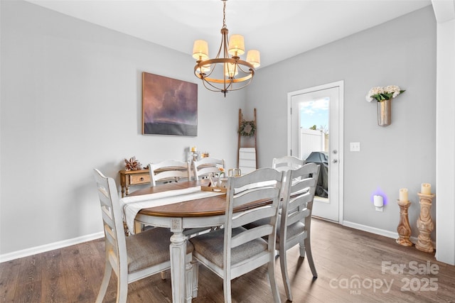 dining area featuring a notable chandelier and dark hardwood / wood-style floors