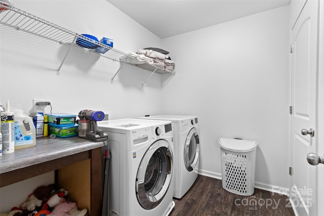 laundry area featuring washing machine and dryer and dark hardwood / wood-style floors