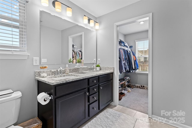 bathroom with vanity, tile patterned flooring, and toilet