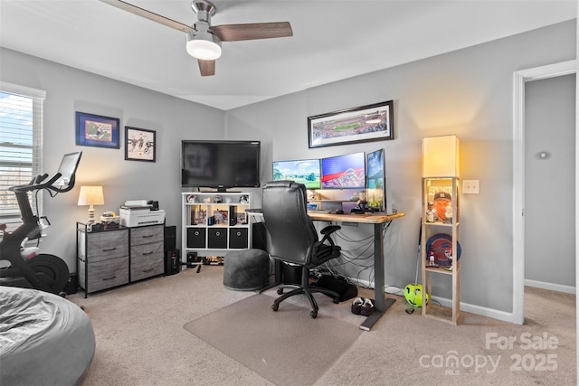 carpeted office featuring ceiling fan