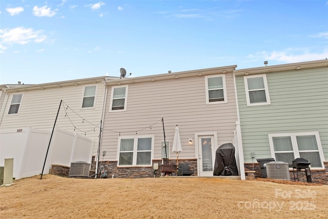 back of house featuring a yard and cooling unit