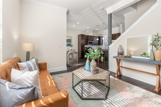 living room with dark wood-type flooring and ornamental molding