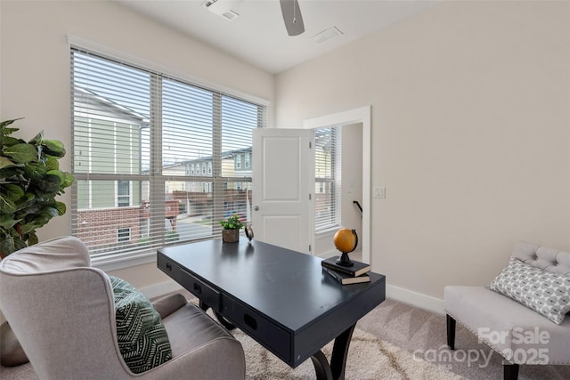 carpeted office space featuring ceiling fan