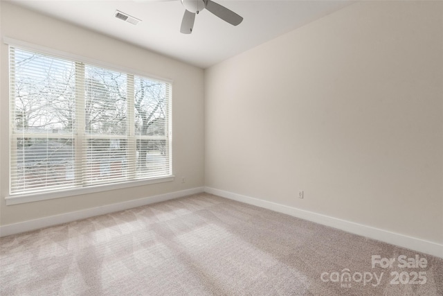 carpeted empty room featuring ceiling fan