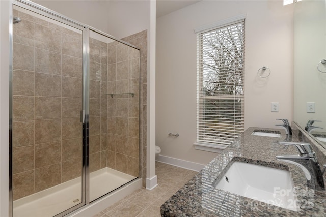 bathroom featuring an enclosed shower, vanity, tile patterned floors, and toilet