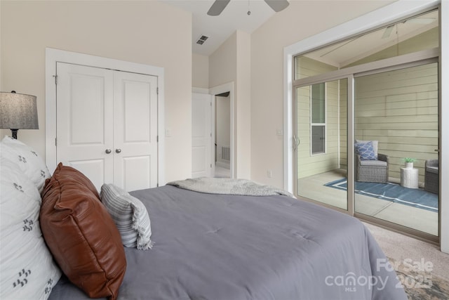 bedroom with ceiling fan, lofted ceiling, carpet floors, and a closet