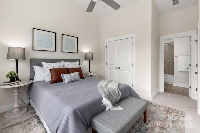 bedroom with carpet floors, connected bathroom, ceiling fan, and a closet