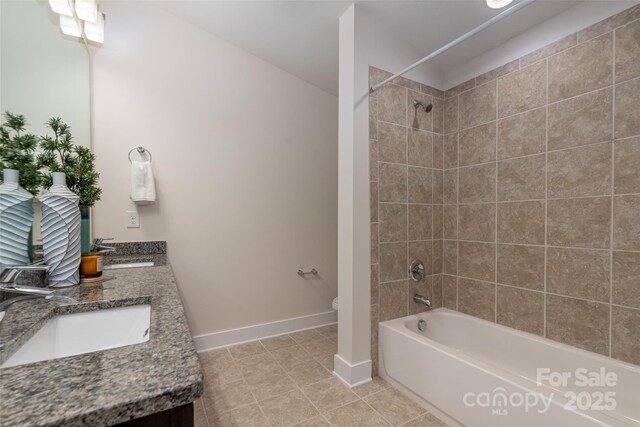 full bathroom with vanity, tiled shower / bath, tile patterned floors, and toilet