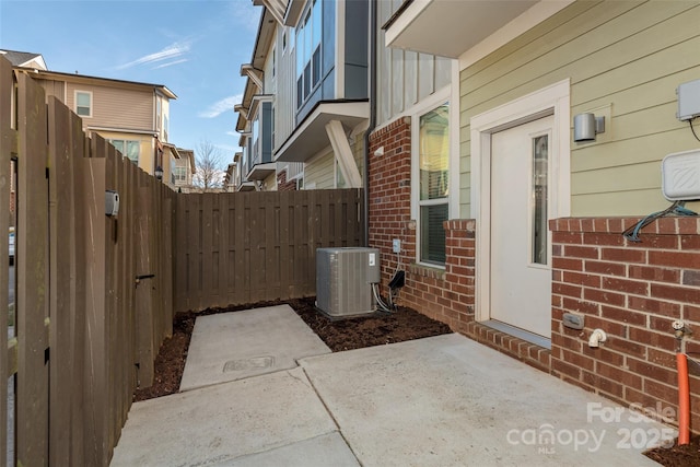 exterior space with central AC unit and a patio area