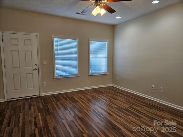 interior space featuring dark wood finished floors, visible vents, and baseboards