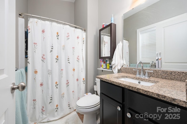 bathroom with vanity, toilet, and a shower with shower curtain