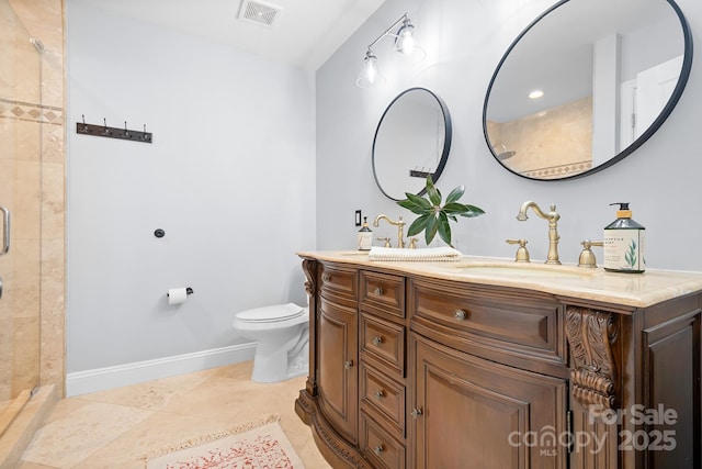 bathroom with vanity, toilet, tile patterned floors, and walk in shower