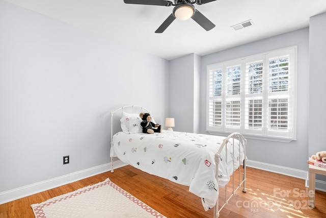 bedroom with hardwood / wood-style flooring and ceiling fan