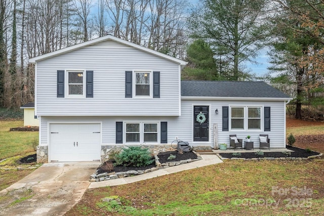 split level home featuring a garage and a front lawn