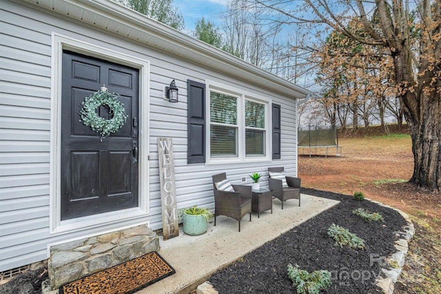 view of exterior entry featuring a patio