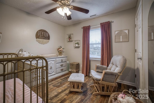 bedroom featuring dark hardwood / wood-style floors and a textured ceiling