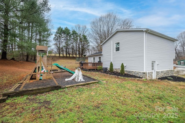 exterior space with central AC unit, a yard, and a deck