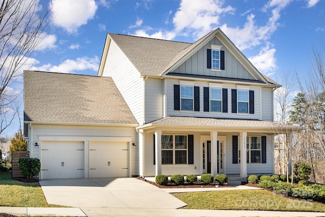 view of front facade with a garage, a front lawn, and covered porch