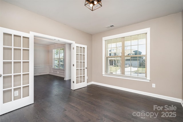 unfurnished room with dark hardwood / wood-style flooring and french doors