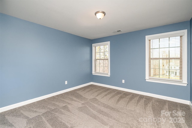 unfurnished room featuring carpet flooring