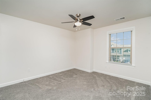 unfurnished room with ceiling fan and carpet