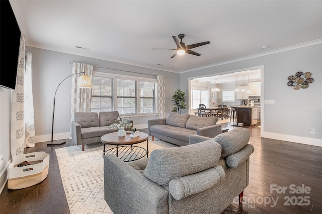 2201 Bluebell Way, Tega Cay, SC 29708 - living area featuring crown molding, a ceiling fan, baseboards, wood finished floors, and a chandelier