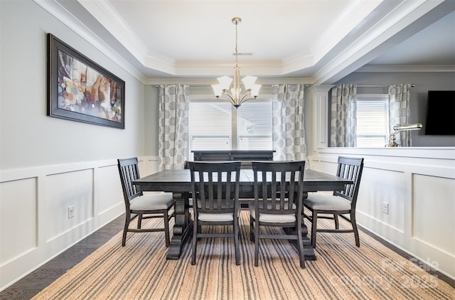 2201 Bluebell Way, Tega Cay, SC 29708 - dining area with a chandelier, a decorative wall, a raised ceiling, crown molding, and a wainscoted wall