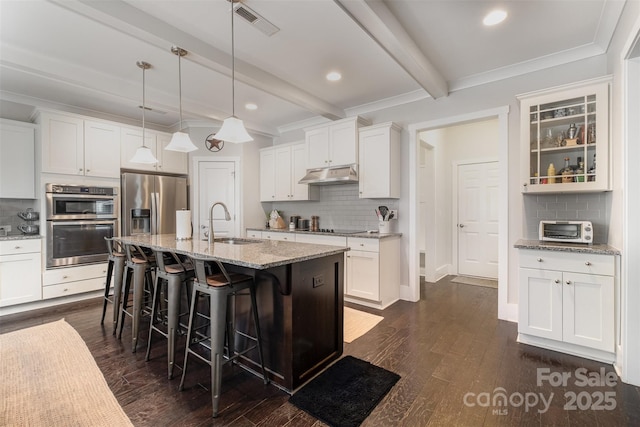 2201 Bluebell Way, Tega Cay, SC 29708 - kitchen with under cabinet range hood, decorative backsplash, a sink, a kitchen breakfast bar, and beamed ceiling