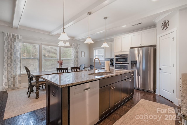 2201 Bluebell Way, Tega Cay, SC 29708 - kitchen with appliances with stainless steel finishes, a sink, light stone counters, beamed ceiling, and pendant lighting