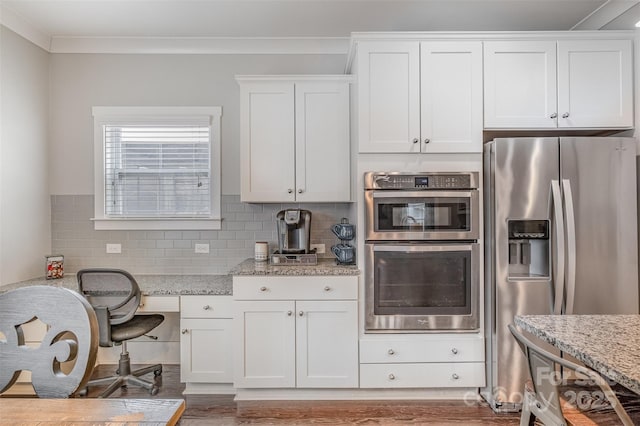 2201 Bluebell Way, Tega Cay, SC 29708 - kitchen with appliances with stainless steel finishes, white cabinetry, light stone countertops, backsplash, and crown molding