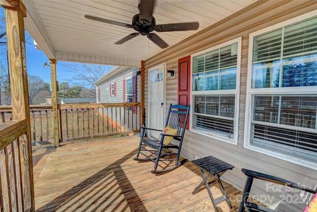 wooden terrace featuring ceiling fan and covered porch