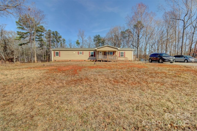 view of front of house featuring covered porch and a front yard