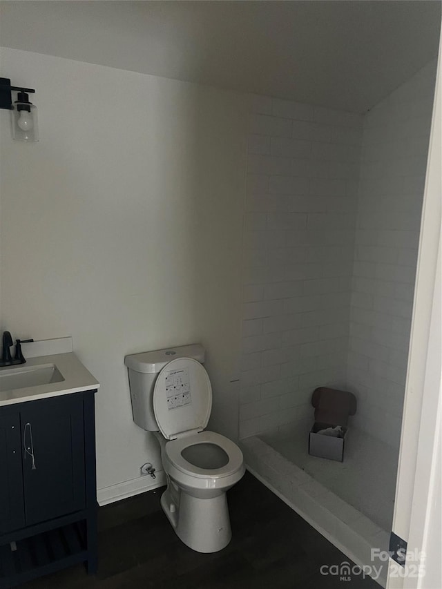 bathroom featuring toilet and vanity