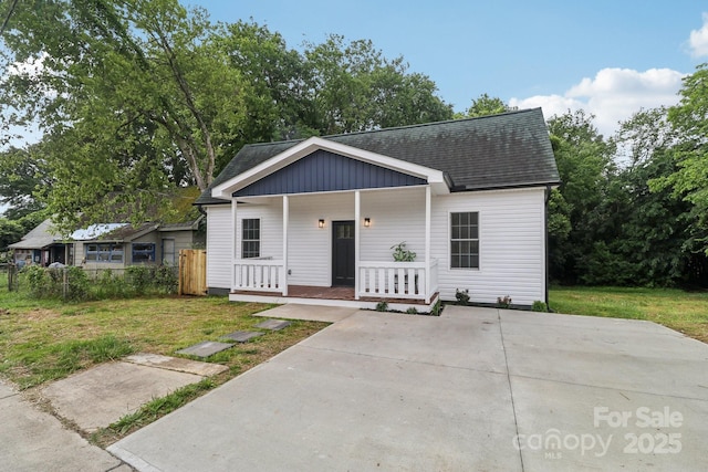 211 Brooklyn Ave, Lancaster, SC 29720 - view of front of home featuring covered porch, a shingled roof, and a front lawn
