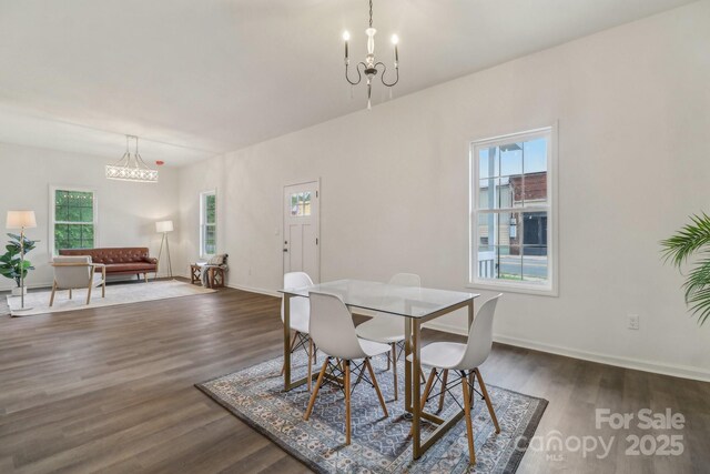211 Brooklyn Ave, Lancaster, SC 29720 - dining area featuring a chandelier, dark wood-style floors, and baseboards