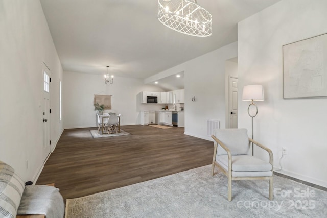 211 Brooklyn Ave, Lancaster, SC 29720 - living room featuring a chandelier, wood finished floors, and baseboards