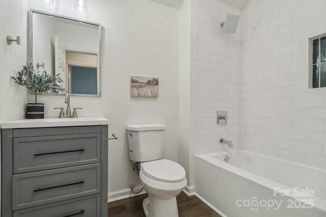 211 Brooklyn Ave, Lancaster, SC 29720 - full bath featuring toilet, vanity, wood finished floors, bathtub / shower combination, and baseboards