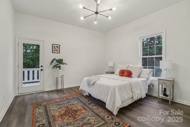 211 Brooklyn Ave, Lancaster, SC 29720 - bedroom with a chandelier, dark wood-type flooring, baseboards, and access to exterior