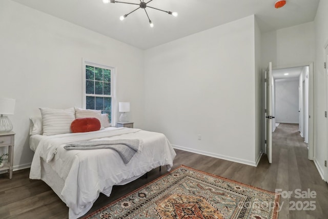 211 Brooklyn Ave, Lancaster, SC 29720 - bedroom with a chandelier, wood finished floors, and baseboards