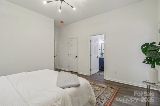 211 Brooklyn Ave, Lancaster, SC 29720 - bedroom with wood finished floors, a chandelier, baseboards, and connected bathroom
