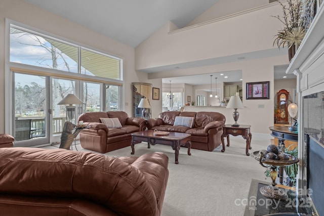 living room featuring light colored carpet and high vaulted ceiling