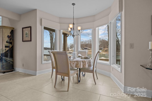 tiled dining room with an inviting chandelier and plenty of natural light