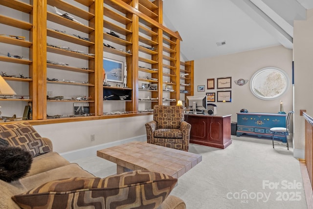 sitting room with vaulted ceiling and light colored carpet