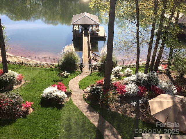 yard at dusk featuring a water view